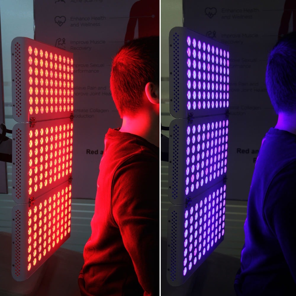 man using red and blue light therapy panel 